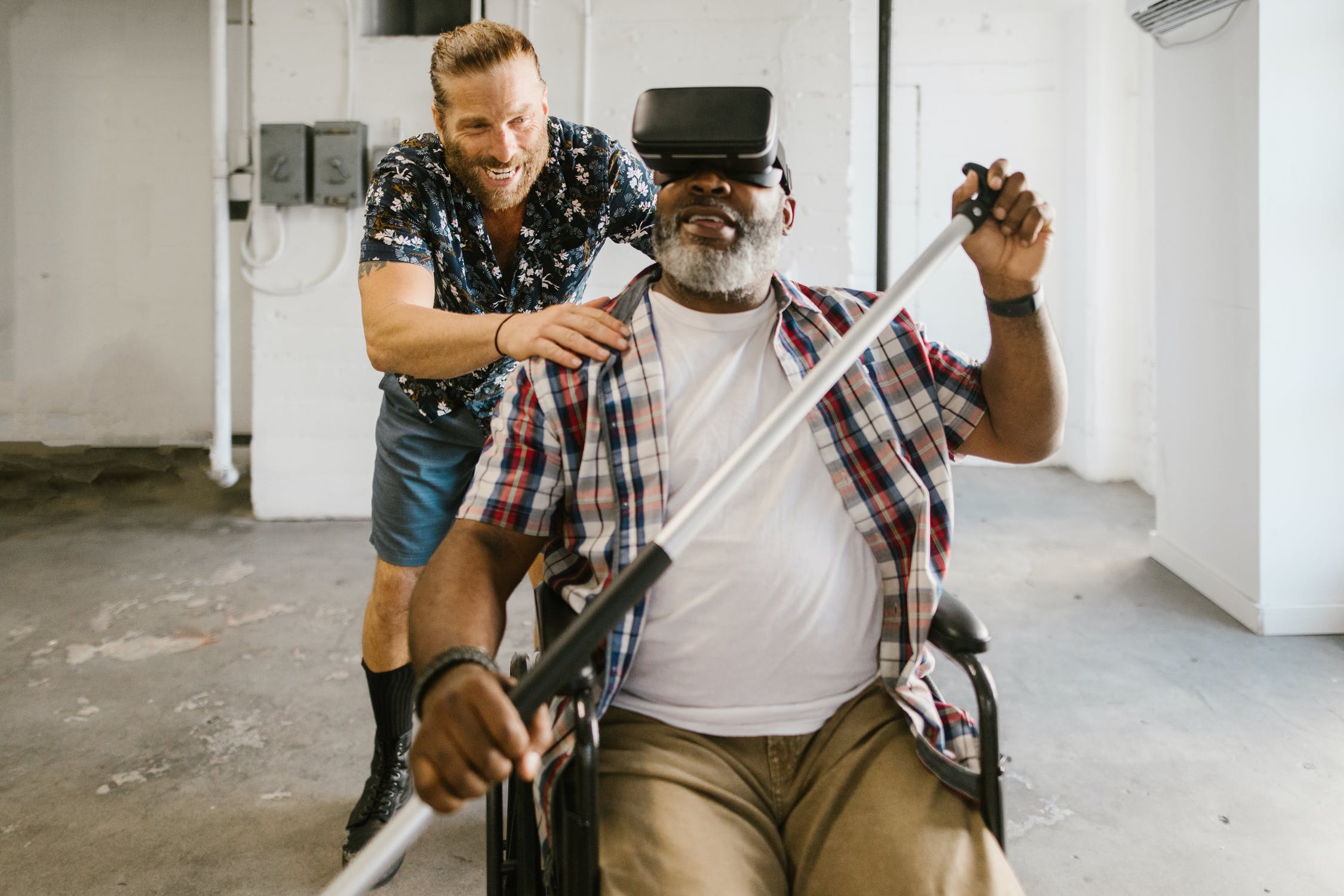 A Therapeutic Recreation professional helps a man in a wheelchair